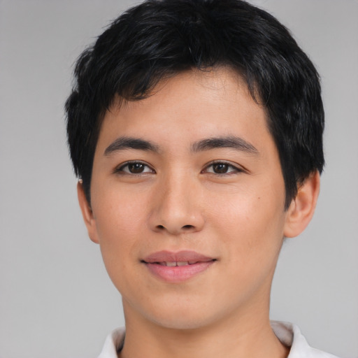 Joyful asian young-adult male with short  black hair and brown eyes