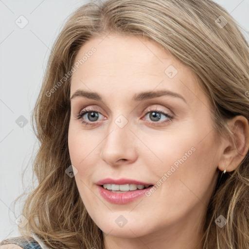 Joyful white young-adult female with long  brown hair and blue eyes