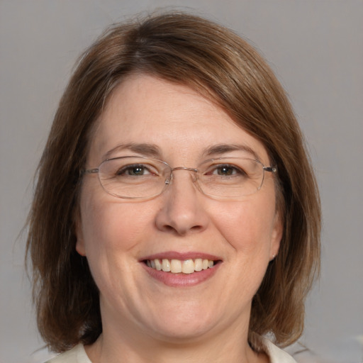 Joyful white adult female with medium  brown hair and brown eyes