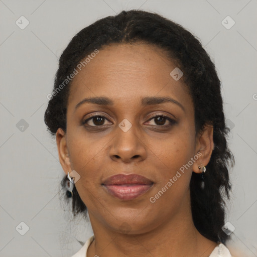 Joyful black adult female with medium  brown hair and brown eyes