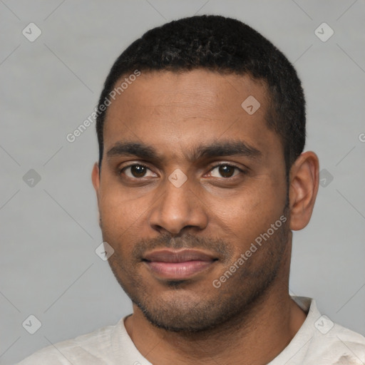 Joyful black young-adult male with short  black hair and brown eyes