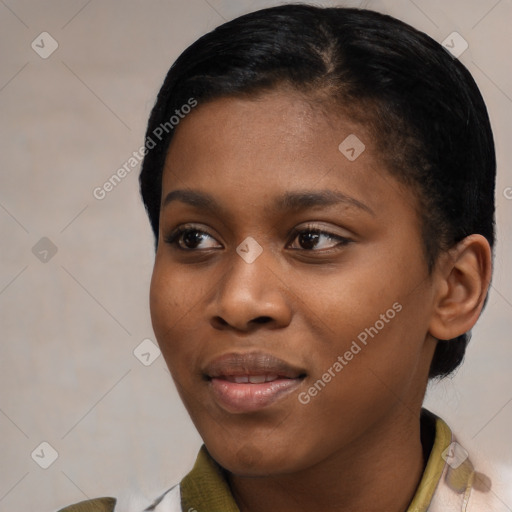 Joyful black young-adult female with short  black hair and brown eyes