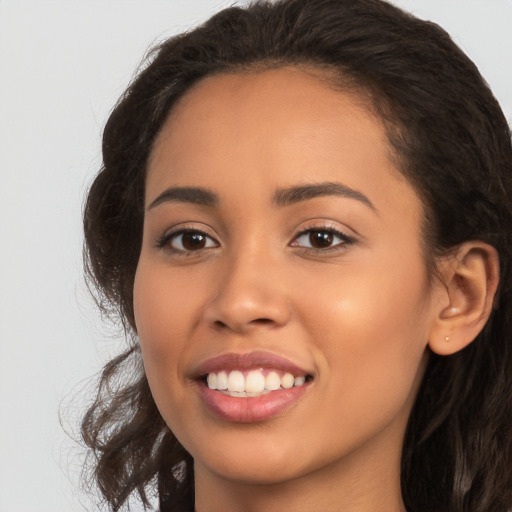 Joyful white young-adult female with long  brown hair and brown eyes