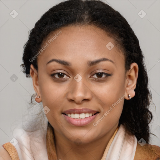 Joyful black young-adult female with long  brown hair and brown eyes