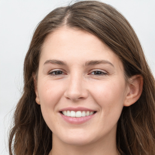 Joyful white young-adult female with long  brown hair and grey eyes