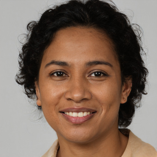 Joyful latino young-adult female with medium  brown hair and brown eyes