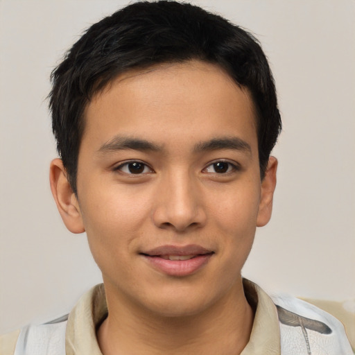 Joyful latino young-adult male with short  brown hair and brown eyes