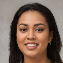 Joyful latino young-adult female with long  brown hair and brown eyes