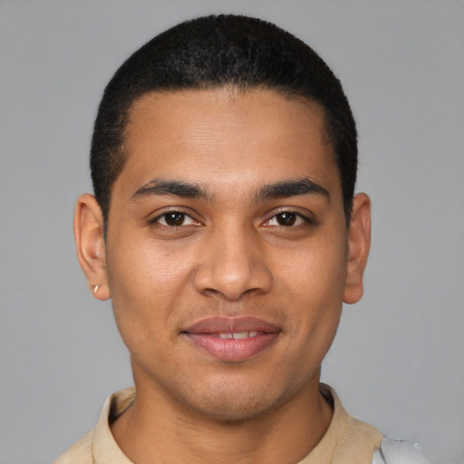 Joyful latino young-adult male with short  black hair and brown eyes