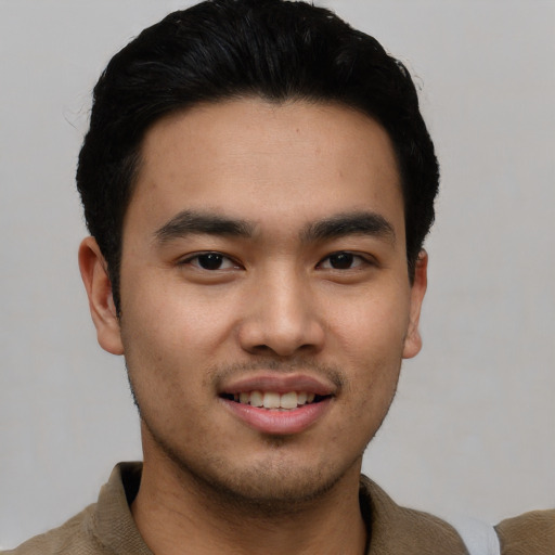 Joyful asian young-adult male with short  black hair and brown eyes