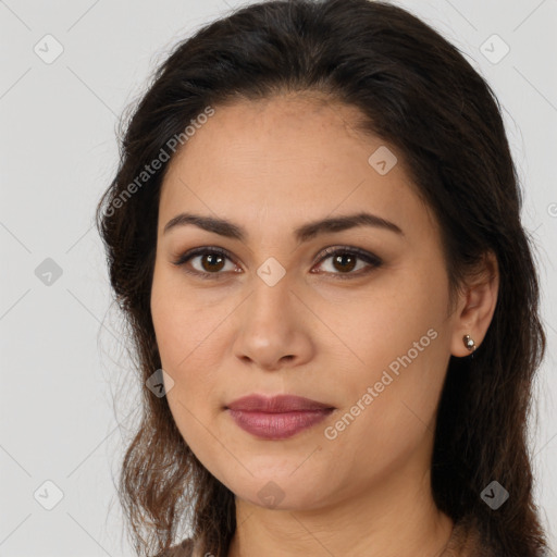 Joyful latino young-adult female with long  brown hair and brown eyes