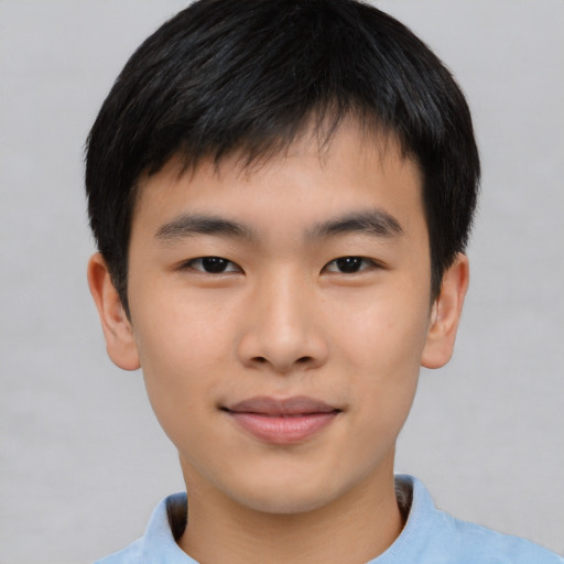 Joyful asian child male with short  brown hair and brown eyes