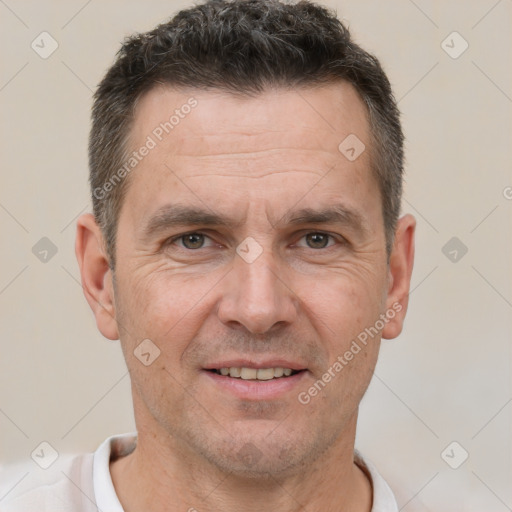 Joyful white adult male with short  brown hair and brown eyes