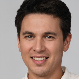 Joyful white young-adult male with short  brown hair and brown eyes