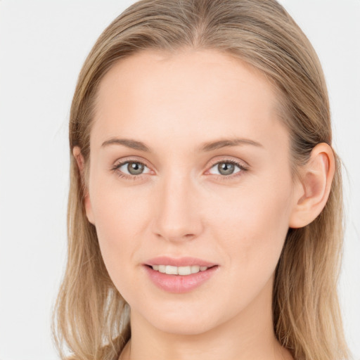 Joyful white young-adult female with long  brown hair and blue eyes