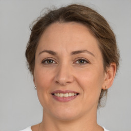 Joyful white adult female with medium  brown hair and brown eyes