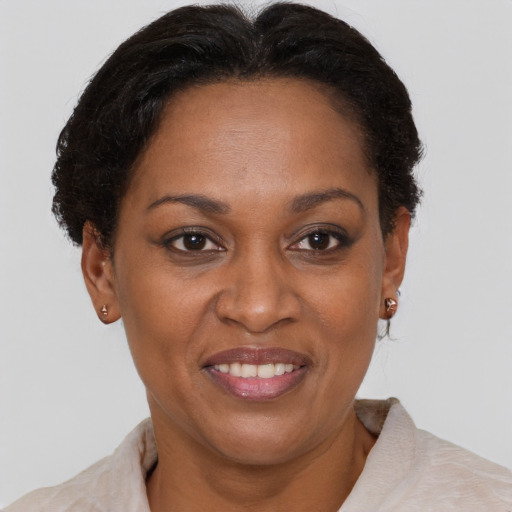 Joyful black adult female with short  brown hair and brown eyes