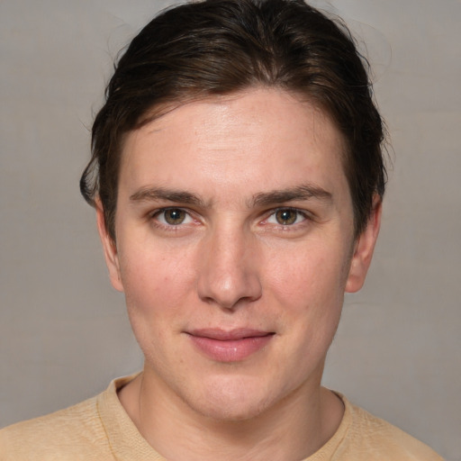 Joyful white young-adult female with short  brown hair and grey eyes