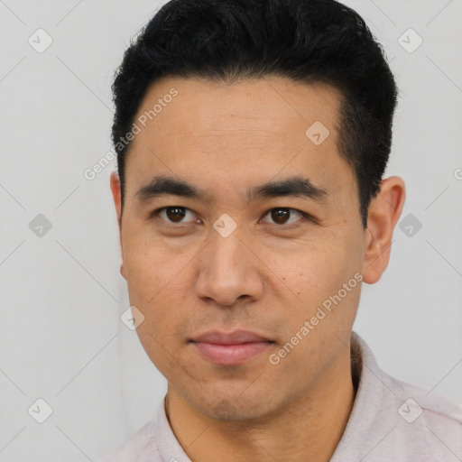 Joyful latino young-adult male with short  black hair and brown eyes