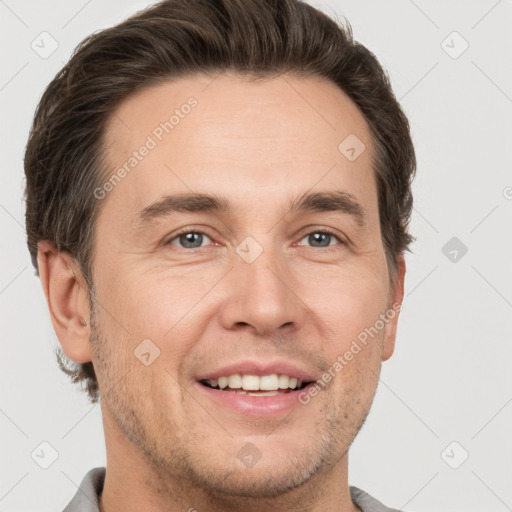 Joyful white adult male with short  brown hair and grey eyes