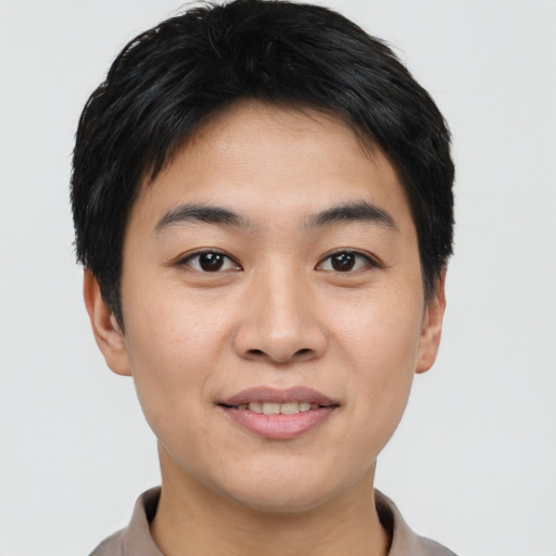 Joyful asian young-adult male with short  black hair and brown eyes
