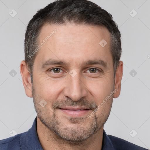 Joyful white adult male with short  brown hair and brown eyes