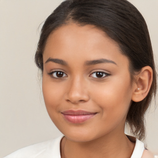 Joyful latino young-adult female with medium  brown hair and brown eyes