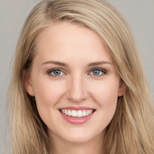 Joyful white young-adult female with long  brown hair and blue eyes