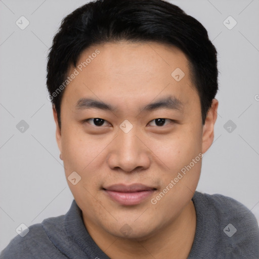 Joyful asian young-adult male with short  black hair and brown eyes