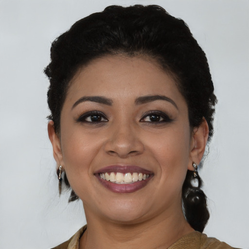 Joyful latino young-adult female with medium  black hair and brown eyes