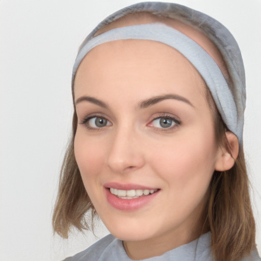 Joyful white young-adult female with medium  brown hair and blue eyes