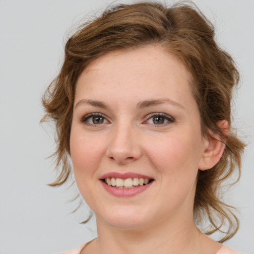 Joyful white young-adult female with medium  brown hair and blue eyes