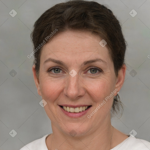 Joyful white adult female with short  brown hair and grey eyes