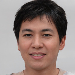 Joyful asian young-adult male with short  brown hair and brown eyes