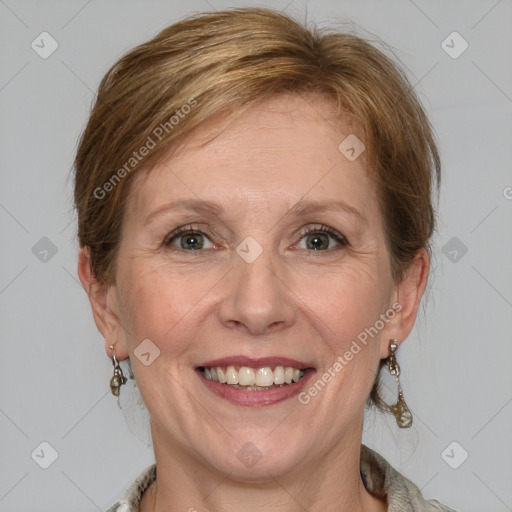 Joyful white adult female with medium  brown hair and blue eyes