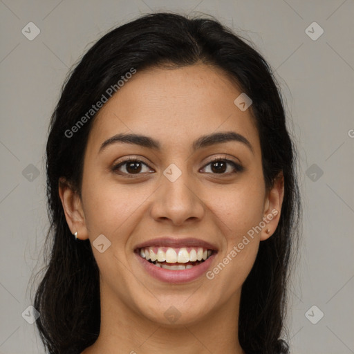 Joyful latino young-adult female with long  brown hair and brown eyes