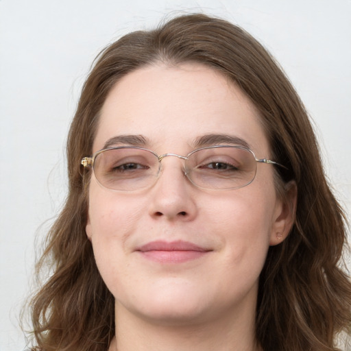 Joyful white young-adult female with long  brown hair and blue eyes