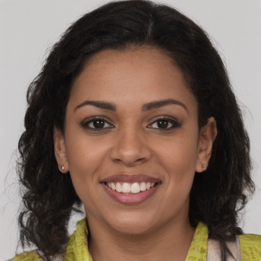 Joyful latino young-adult female with medium  brown hair and brown eyes