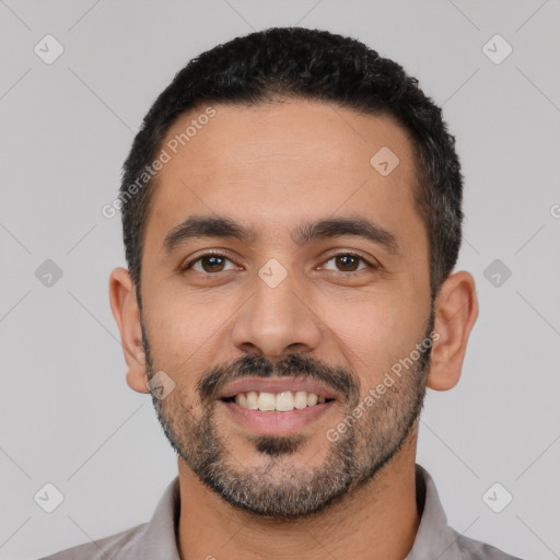 Joyful latino young-adult male with short  black hair and brown eyes