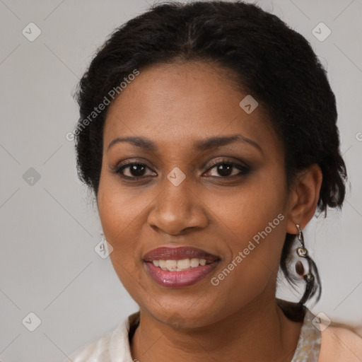 Joyful black adult female with medium  brown hair and brown eyes