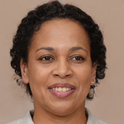 Joyful black adult female with medium  brown hair and brown eyes