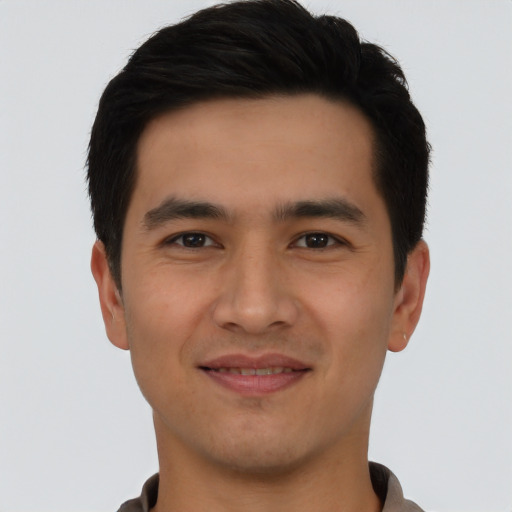 Joyful asian young-adult male with short  brown hair and brown eyes