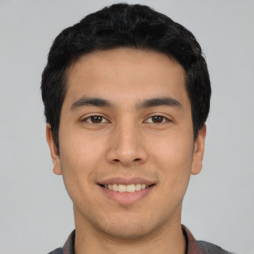 Joyful asian young-adult male with short  black hair and brown eyes