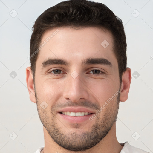 Joyful white young-adult male with short  brown hair and brown eyes