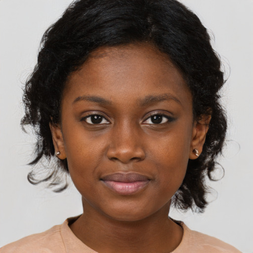 Joyful black young-adult female with medium  black hair and brown eyes