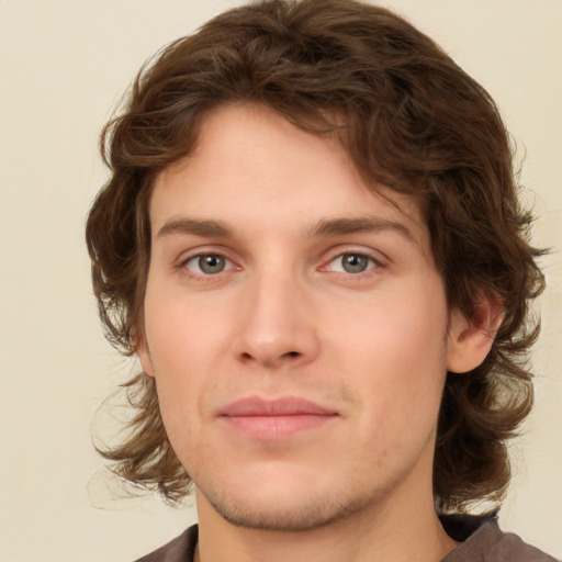 Joyful white young-adult male with medium  brown hair and brown eyes