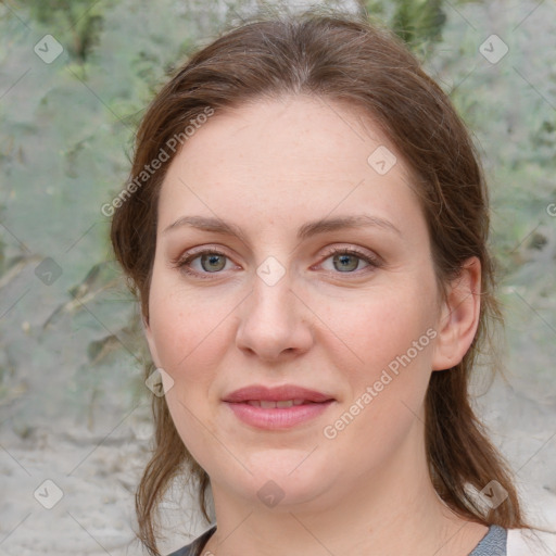 Joyful white young-adult female with medium  brown hair and green eyes