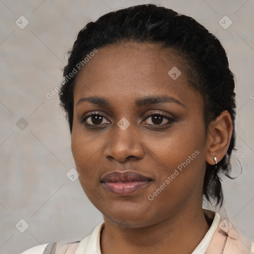 Joyful black young-adult female with short  black hair and brown eyes