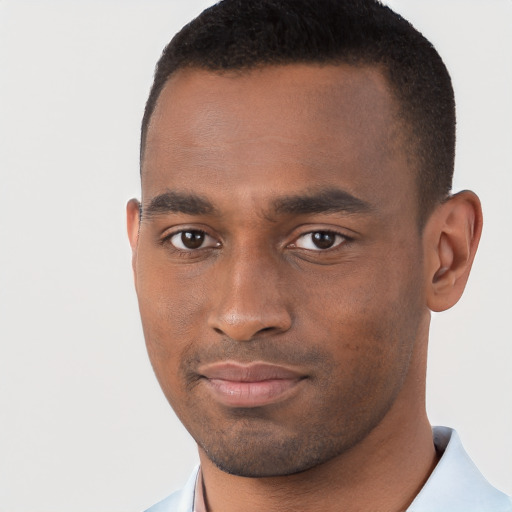 Joyful black young-adult male with short  brown hair and brown eyes