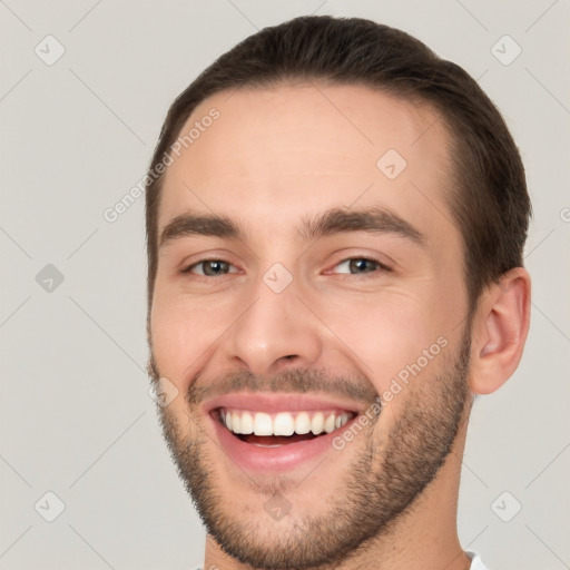 Joyful white young-adult male with short  brown hair and brown eyes